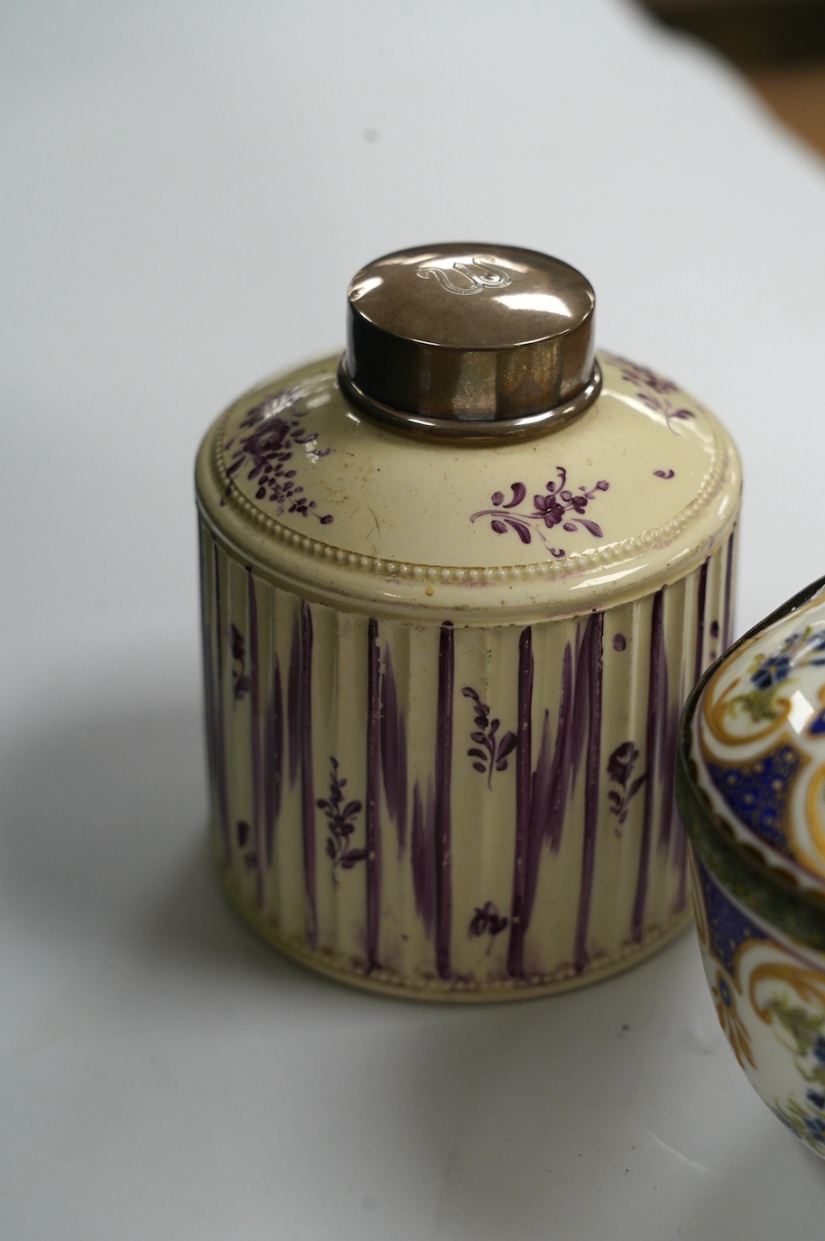 A Dresden porcelain ink stand, 11cm high, and an 18th century English creamware tea caddy with a silver lid, 10cm high. Condition - fair to good